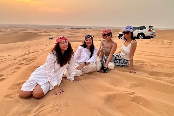 Abu Dhabi Desert Safari Tour with Shows & Buffet Dinner - Sandboarding and the sunset photo stop