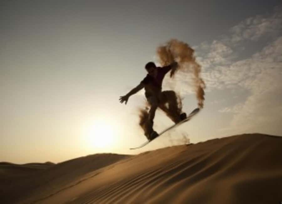 Desert Safari, Quad Bike, Camel Ride, Falcon & Sandboarding - Sandboarding from the high dunes