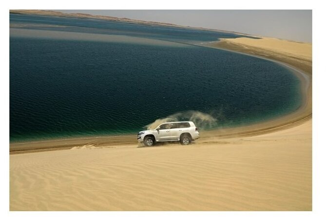 Doha Half Day Desert Safari Dune Bashing CamelRide & Sandboarding - Sandboarding on soft dunes