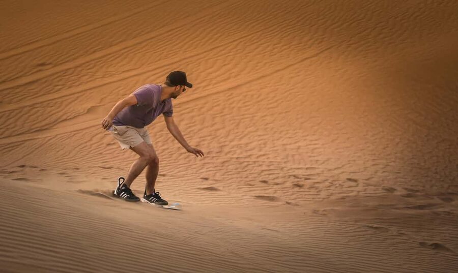 Doha: Sunset Desert Safari, ATV, Camel Ride and Sandboarding - Sandboarding down the dunes