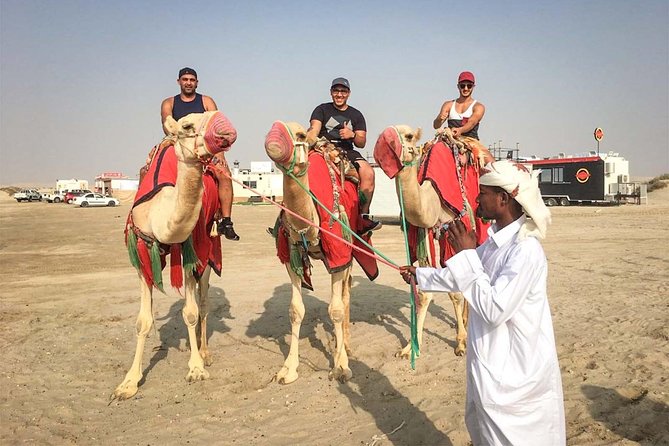 Doha: Sunset Desert Safari, Camels, Sandboarding & Inland Sea - Sandboarding on soft Qatar dunes