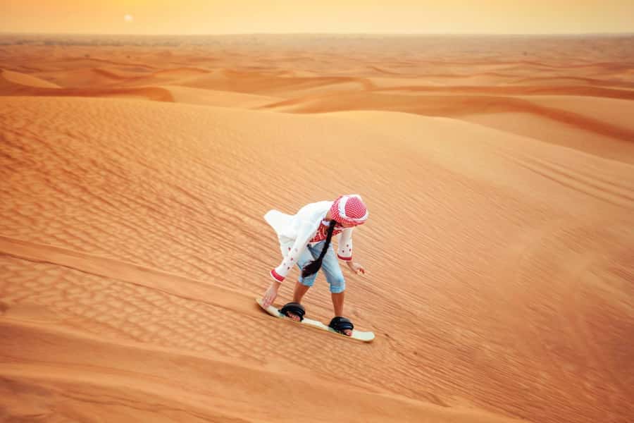 Dubai: Desert Safari, Camel Ride, and BBQ Dinner - Sand boarding and the sunset stop