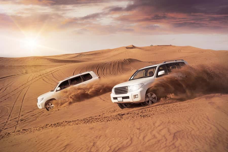Dubai: Desert Safari, Camel Ride, and BBQ Dinner - Dune bashing across the sand