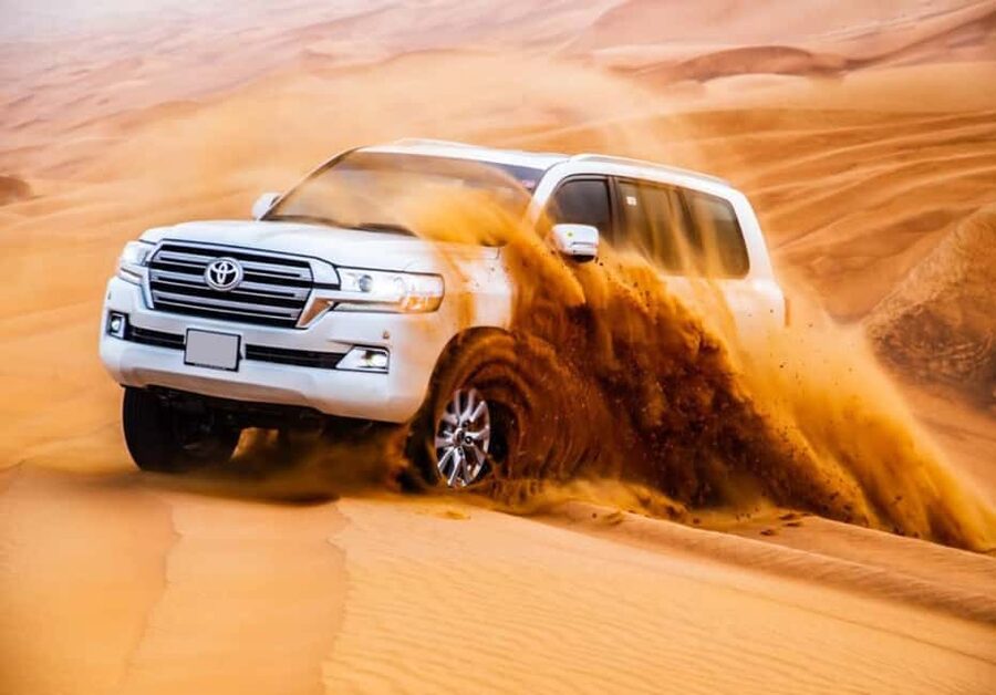Dubai: Desert Safari, Camel Ride, Quad Bike & BBQ Dinner - Camel riding and sandboarding