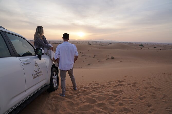 Dubai Desert Safari: Camel Ride, Sandboarding, BBQ & House Drinks - Camel riding and sandboarding at the camp