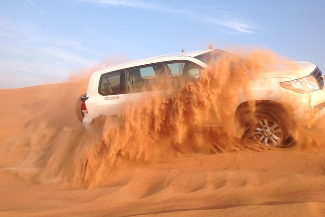 Dubai: Desert Safari, Camel Ride, Show & Optional Dinner - Sandboarding on the red dunes