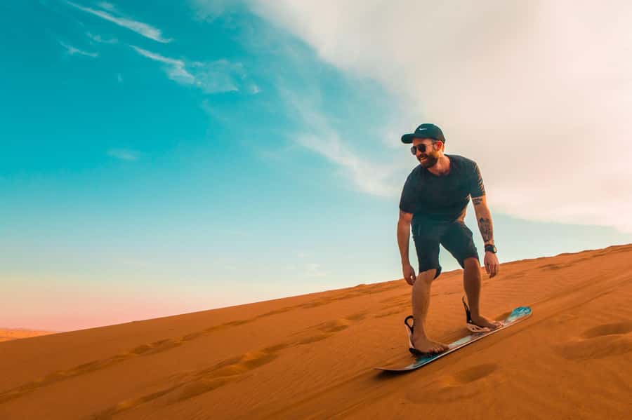 Dubai: Desert Safari, Quad Bike, Sandboarding, Camels & BBQ - Dune bashing and sandboarding on the red sand