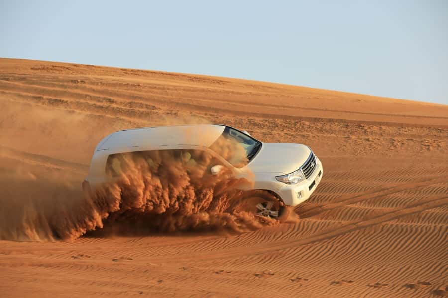 Dubai: Desert Safari, Quad Bike, Sandboarding, Camels & BBQ - Camel riding, sunset photographs, and a slower desert moment