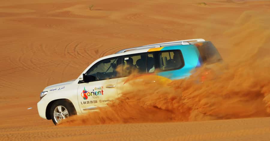 Dubai Desert Safari, Quad Biking, Camel Ride, & Sandboarding - Sandboarding on a short desert session