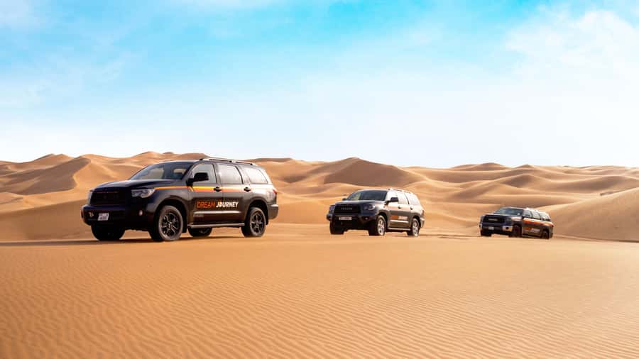 Dubai Desert Safari - Sandboarding, Quad Bike & BBQ Options - Sunset, sandboarding, and a short camel ride