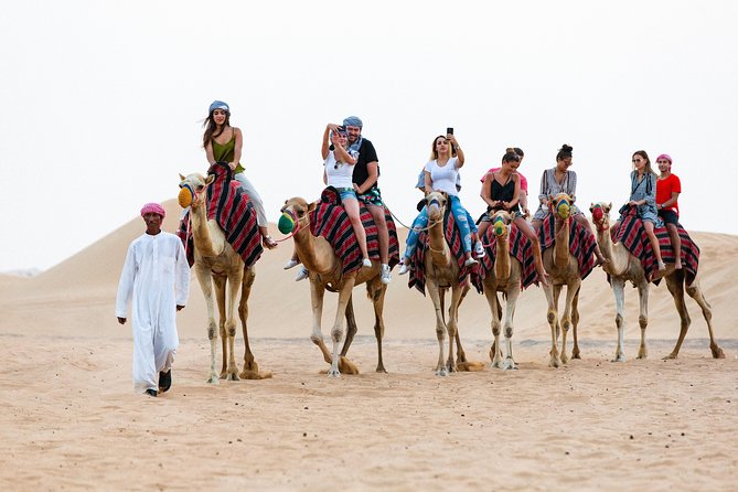 Dubai Desert Safari with Quads, BBQ Dinner, Camel ride, & Shows - Quad biking across the sand