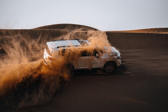 Dubai Evening Desert Safari: Sandboarding, BBQ, Camel Ride & more - Camel riding and sandboarding in the reserve