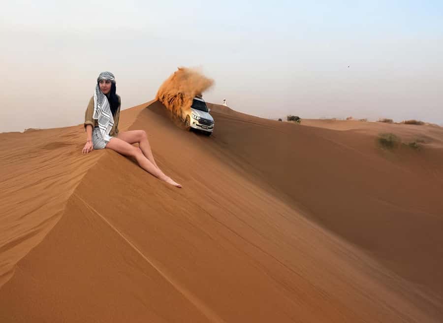Dubai: Red Dunes Desert Safari with Premium Camp BBQ & Shows - Holding on during the 30-minute dune drive