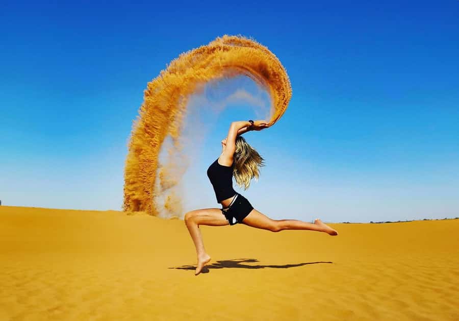Dubai: Red Dunes Desert Safari with Premium Camp BBQ & Shows - Sandboarding above the desert floor