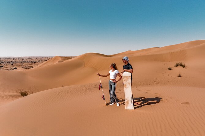 Dubai Red Dunes Safari: Dune Bashing, Camel Ride & Breakfast - Sandboarding on the red sand