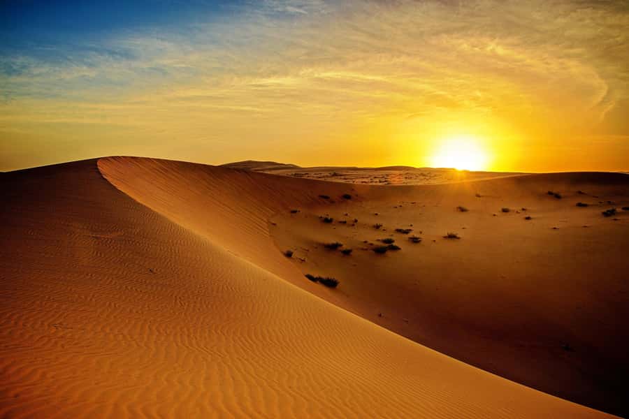 A single lit dune ridge at last light on a desert safari