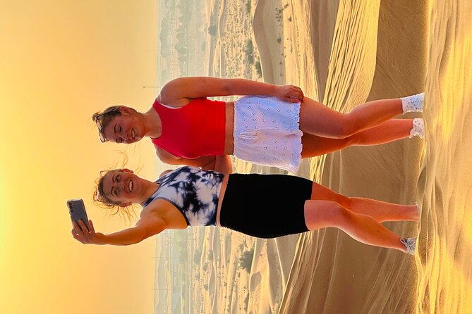 Dubai Sunset Red Dune Desert Safari, Sandboarding and Camel Ride - Sandboarding on a red dune