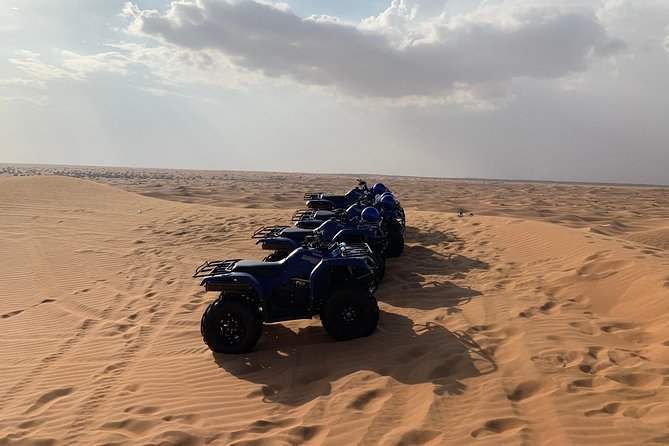 Dubai: Unique SUNSET Quad Bike Red Dunes Safari - A camel ride for a slower view